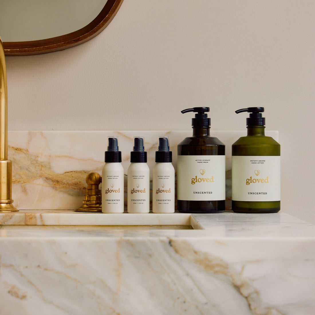 The Unscented Starter Set on a marble basin: three mini lotions, the hand wash and the hand lotion